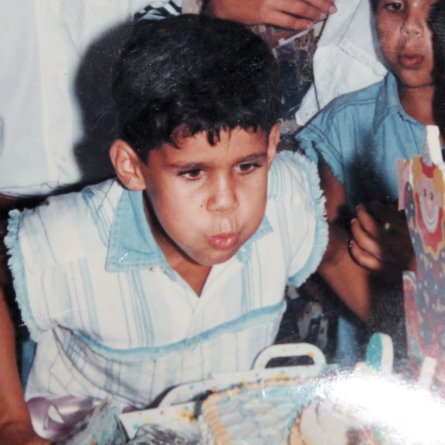 Diego Costa as a child, blowing off candles at his birthday.