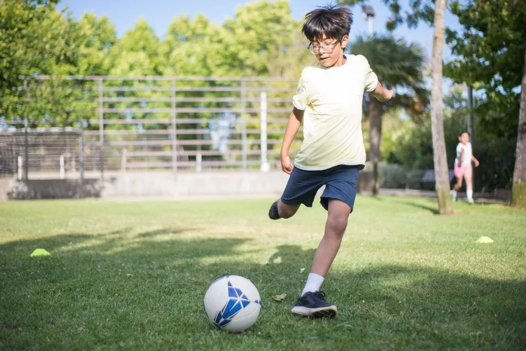 Illustrative stock photo: child playing soccer