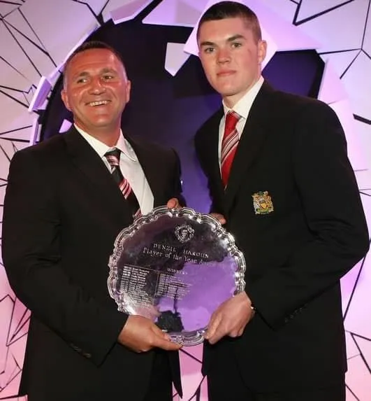 Michael Keane (R) is presented with the Reserve Player of the Year trophy by Reserve team manager Warren Joyce in May 2012. Credits: Liverpool Echo.