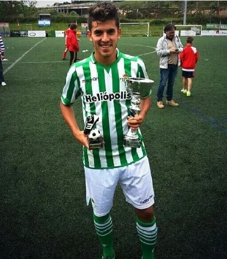 Dani Ceballos holding his Real Betis Trophy and award.
