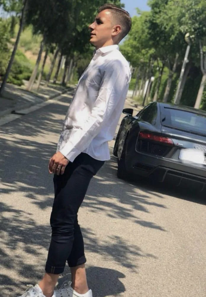 Digne posing next to one of his Audi rides. Image Credit: