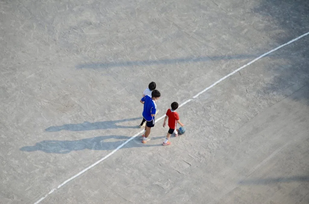 Illustrative stock photo: siblings playing soccer