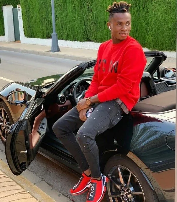 Samuel Chukwueze posing for a shot on his Mazda MX-5 Miata Convertible car. Image Credit: Autojosh.