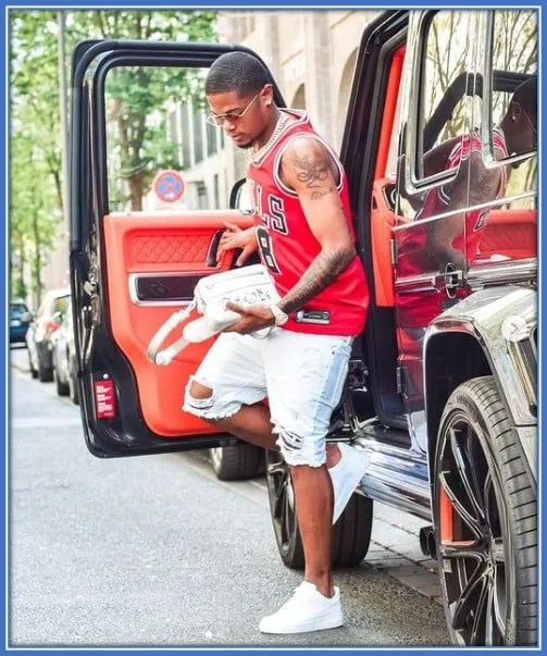 See the winger stepping out of his super exotic car.