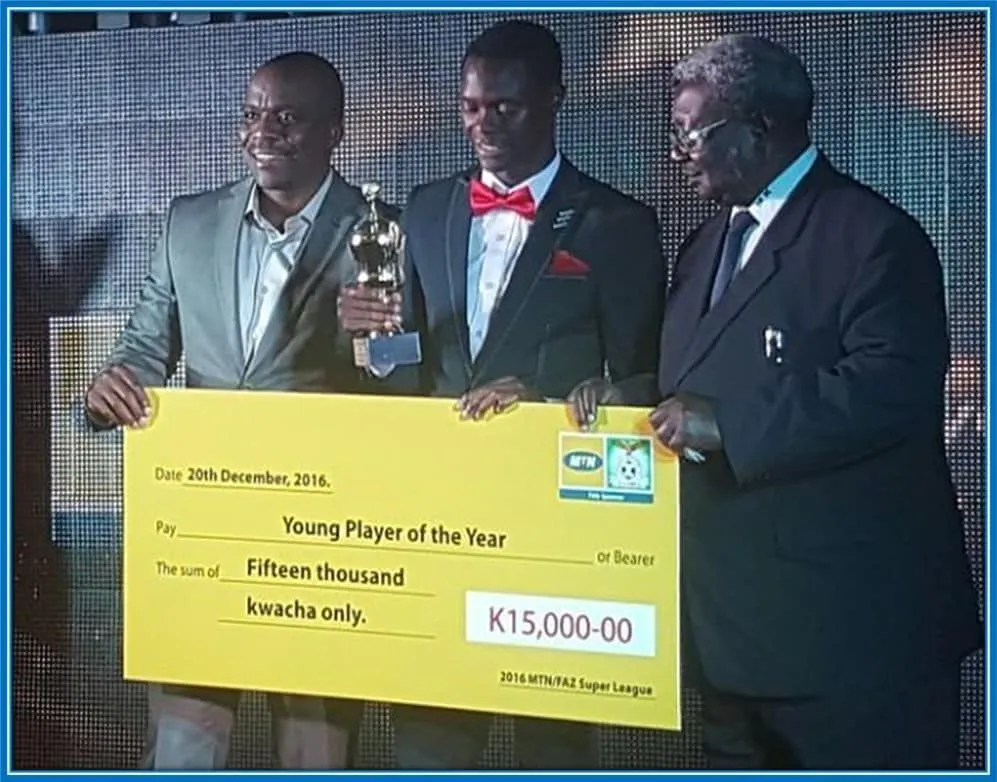 Patson Daka holding the CAF Youth Player of the Year.
