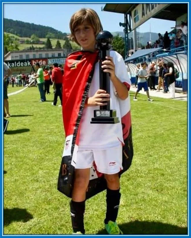 The young Spaniard holds his first-ever trophy.
