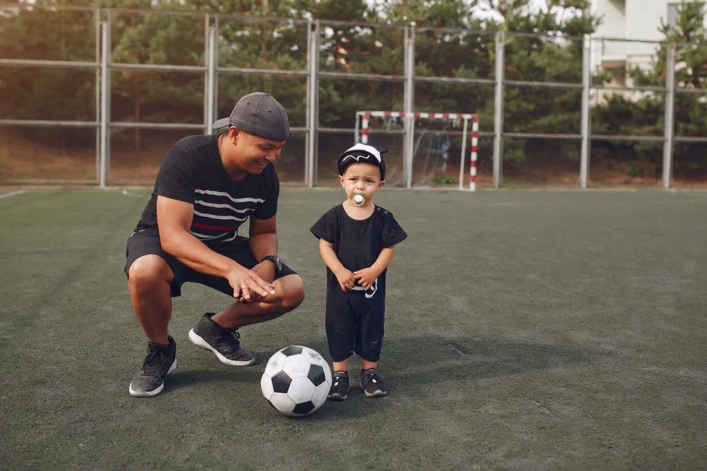 Illustrative stock photo: parent child soccer