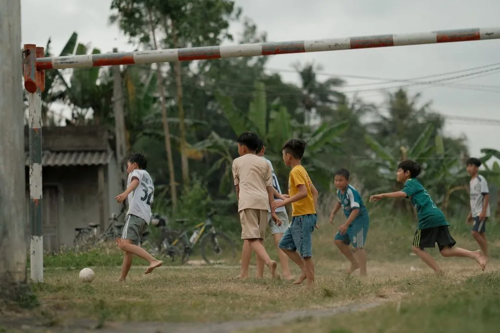 Illustrative stock photo: siblings playing soccer