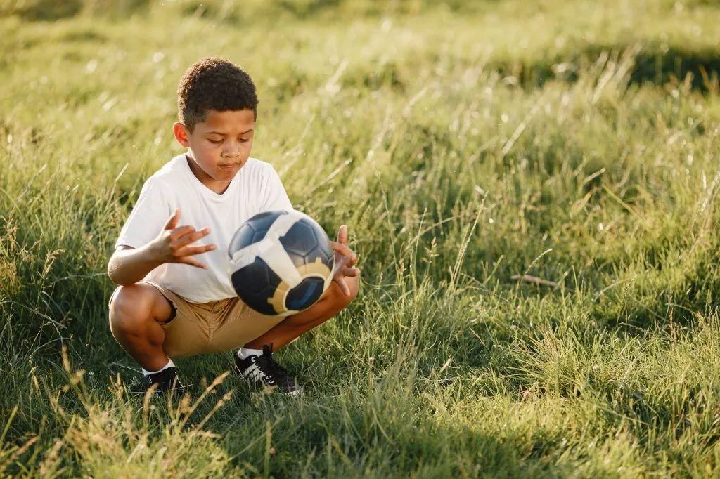 Illustrative stock photo: child playing soccer