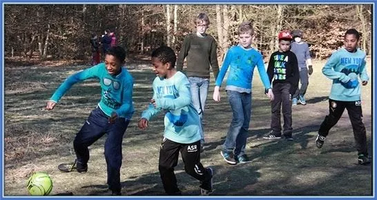 The Timber twins (and their brother, Dylan) are pictured playing football with their schoolmates during one of De Spits's camping sessions.