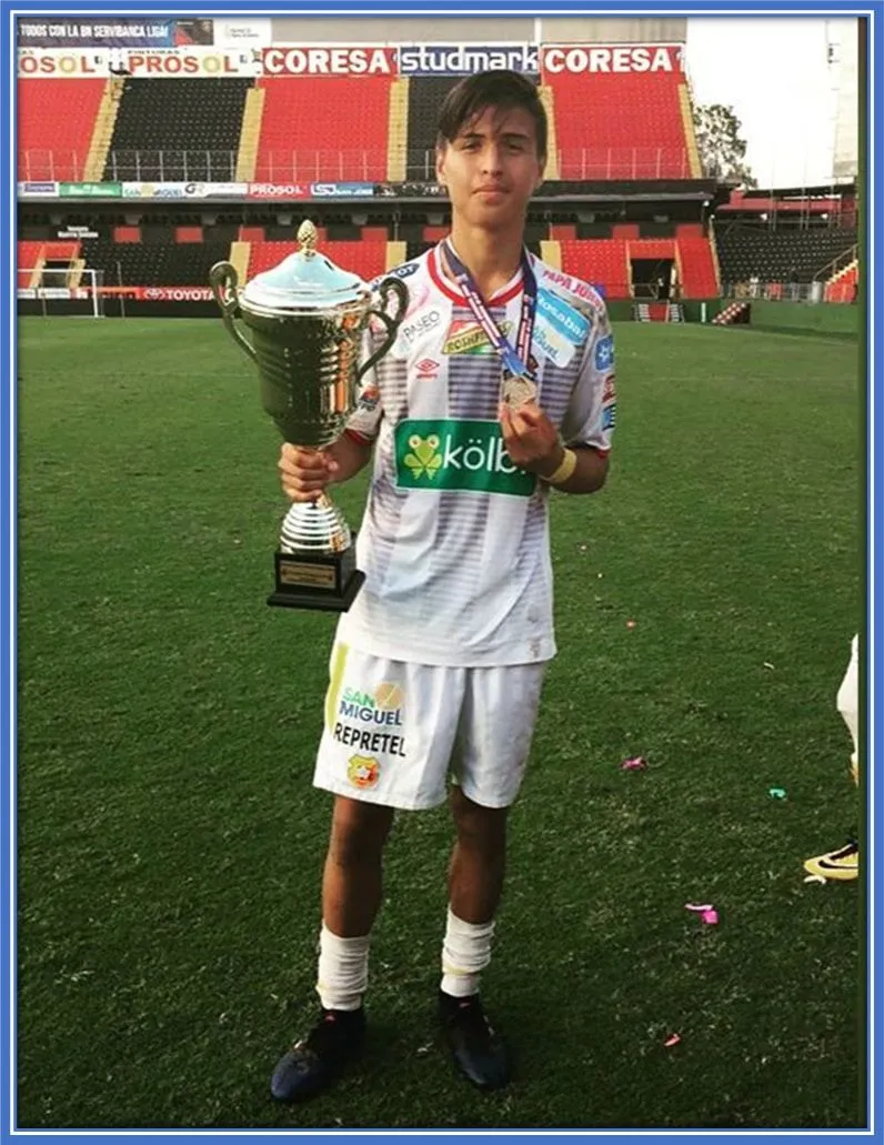Young Anthony (at his youth level) celebrating his trophy and medal.
