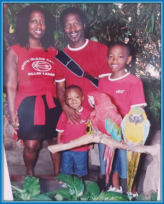 Young Jaidon is pictured admiring a Parrot that steers at him. He stands alongside his Dad, Garry, mum Donna, and big brother Kyneil Grant.