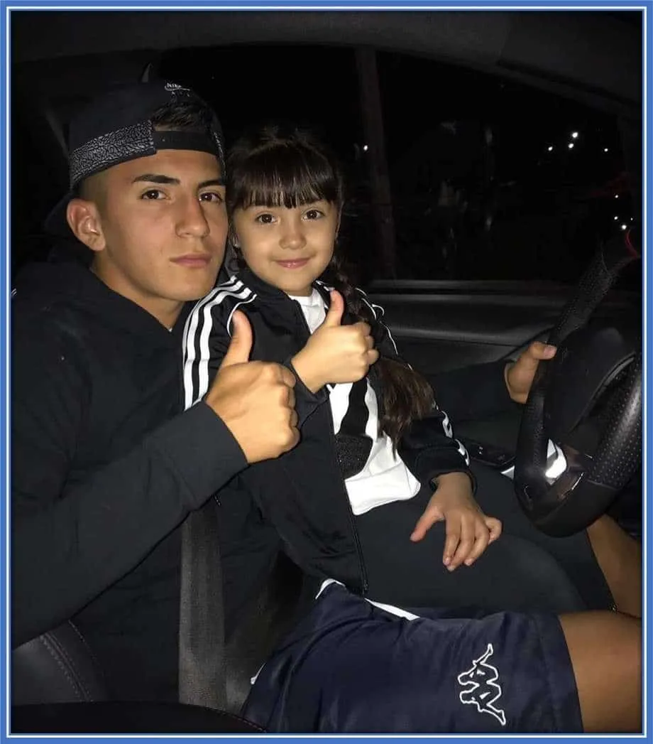 The Argentine Baller is pictured alongside his sister inside his car.