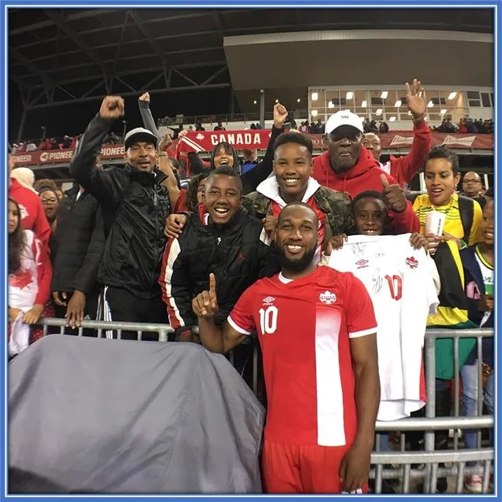 Members of Junior Hoilett's family are pictured throwing their massive weight of support for him after an international match.