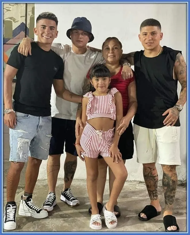 Uma Almada takes a photo with her sons and daughter.