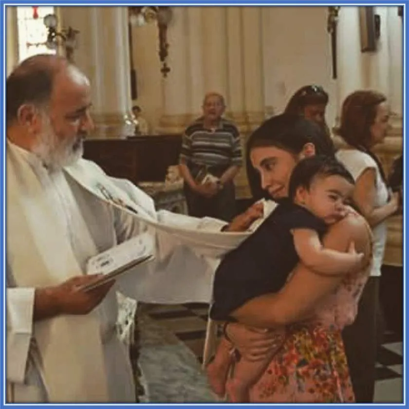 Marcos Acuna's Wife and daughter receiving Father's blessings.