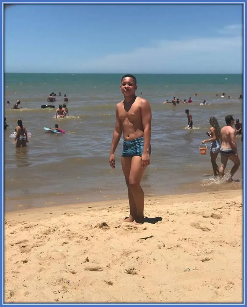 Amidst the waves, he savours the simple joys of life while unwinding at the beach.