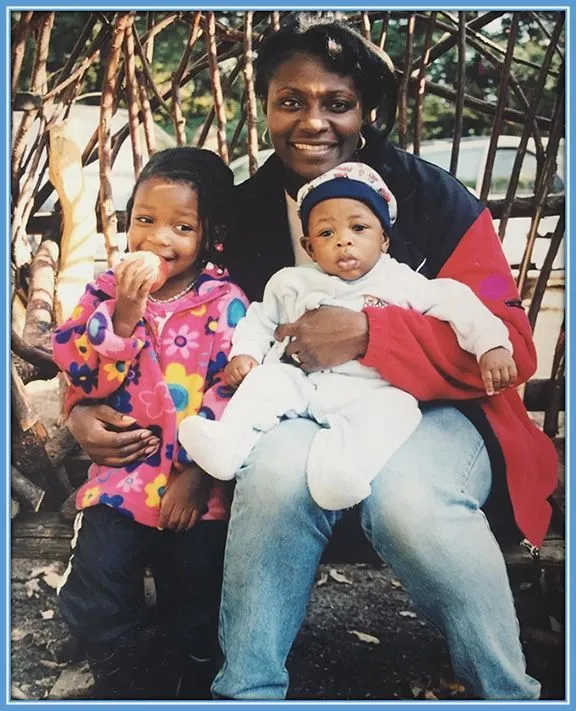 Deanne Rose's mother holding her and carrying her younger brother, Deangelo Rose.