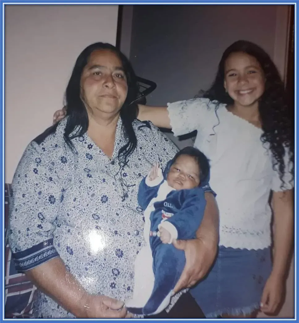 A glimpse into his tender years. A young Endrick Felipe is seen here nestled in his grandmother's loving embrace, with his teenage Aunt Lav&iacute;nia happily standing by.