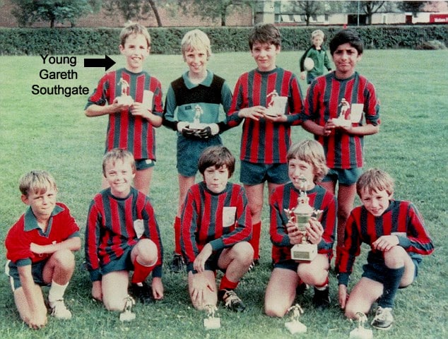 Balancing Brilliance: Young Gareth Southgate juggles academics and sport at Crystal Palace Academy, transitioning from right-back to central midfield. Pictured (back, from the left) with his U12 team, proudly hoisting their latest trophy.