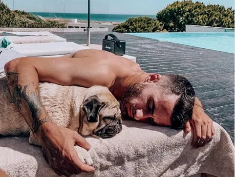 The footballer is pictured spending quality time with his dog.