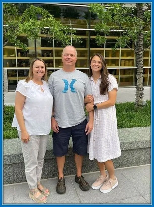 Meet Ashley Hatch's Parents-Barry Hatch (Father) and Anne Marie (Mother), standing with their daughter.