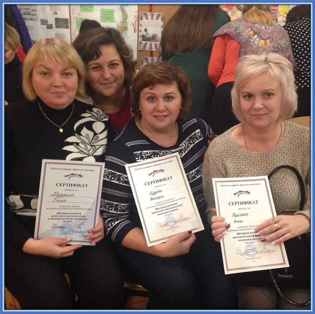 Mykhailo Mudryk's Mum (far left) presents her certificate of achievement with fellow teachers at the school she teaches in Kharkiv Oblast.