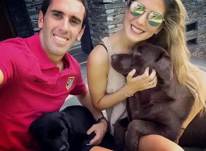 Sofia Herrera and Diego Godin are pictured together with their dog.
