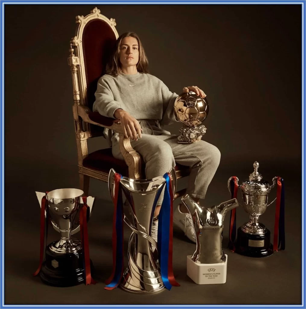 Alexia poses with Ballon d'Or trophies and Women's Champion League, amongst others.