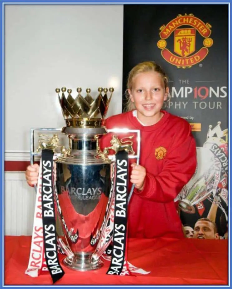 The athlete displayed her trophy during her early career years with Manchester united.