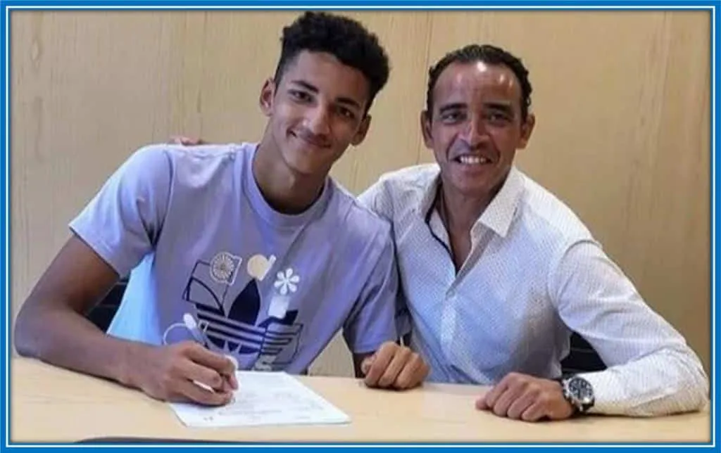 Alvaro Rodriguez takes a photo with Joyce Moreno at signing his professional contract.