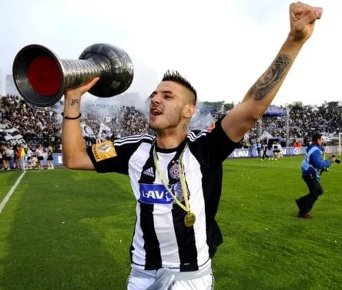 Aleksandar Mitrovic in his youth lifts a trophy. He has led his team to victories since his early career years.