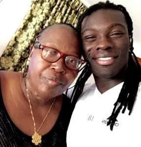 A young Bafetimbi Gomis pcitured sharing a heartwarming smile with his beloved mother.