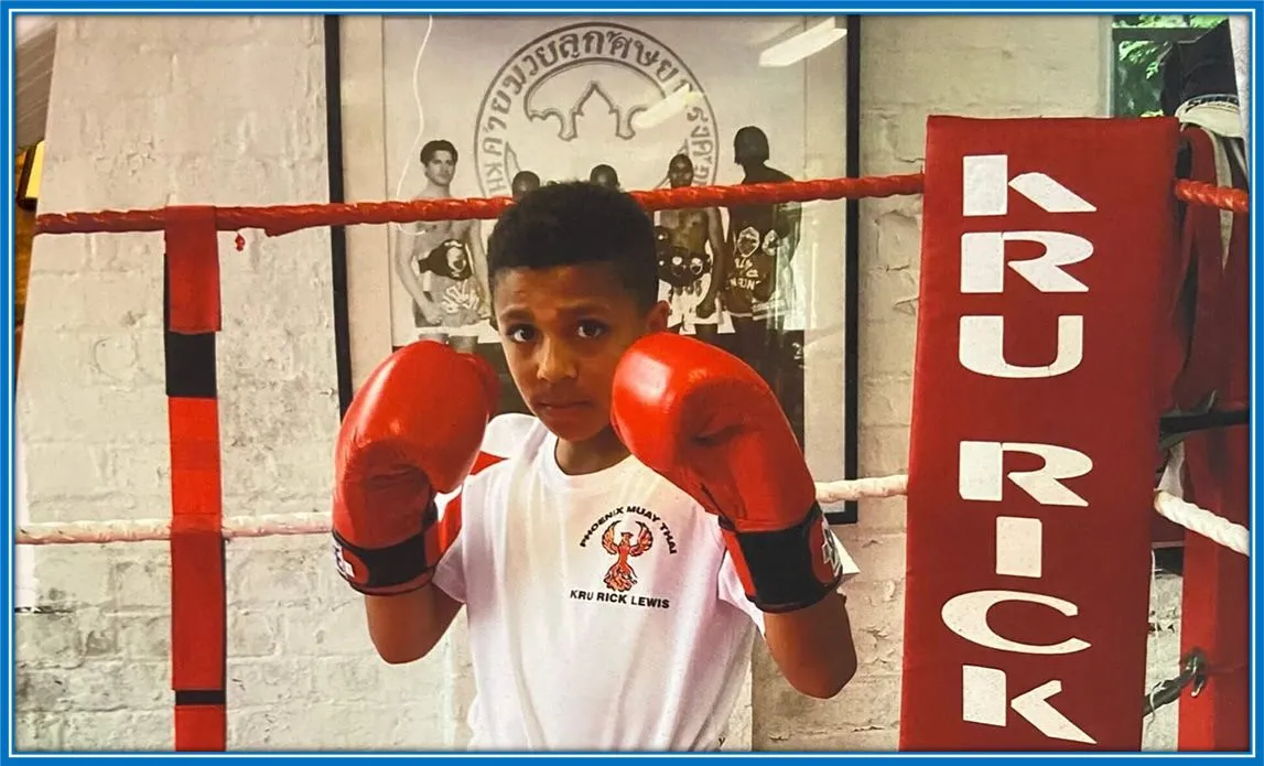 Young Rico wears his boxing glove with pride, knowing that hard work and discipline will lead him to sporting success.