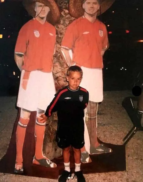 Behold the young boy with big dreams. One of Harry's best memories was taking this photo in front of his heroes.