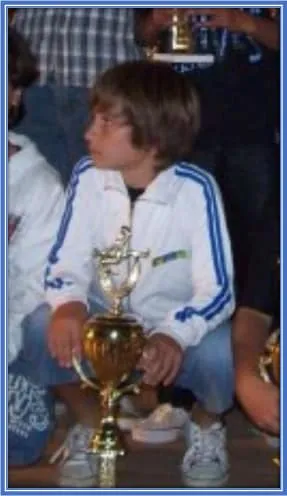 Alexis started his football journey on solid footings. This is him holding his first trophy.