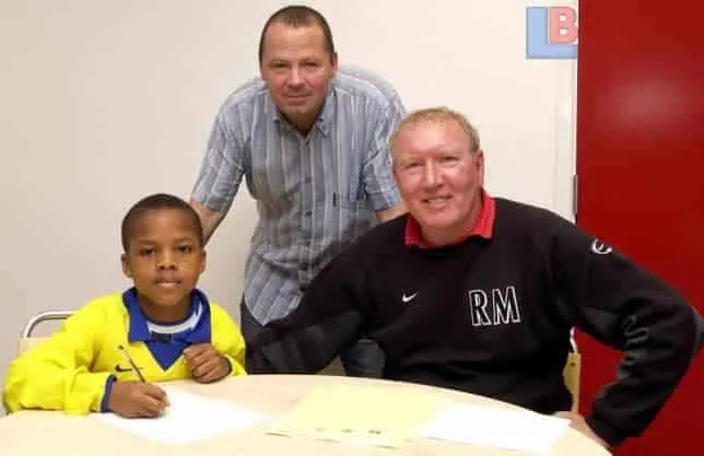This is young Alex Iwobi as he signs his first contract.