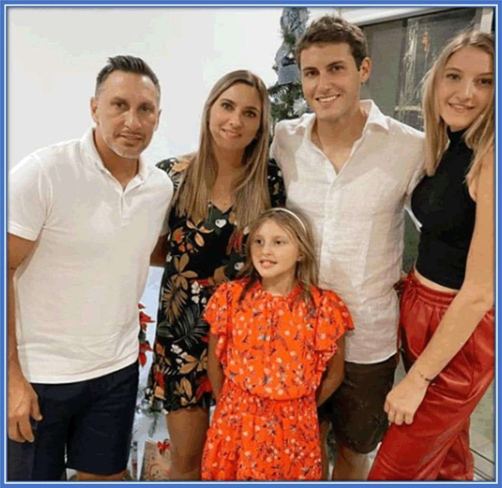 A happy family photo showing Gimenez with his parents and beautiful sisters.