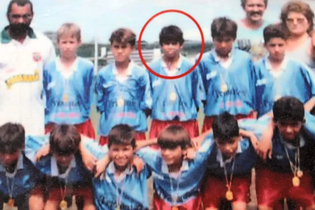 A rare photo of his childhood days with his Football Team.