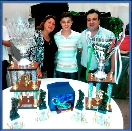 Mariana Alvarez celebrates her son's success alongside her husband.