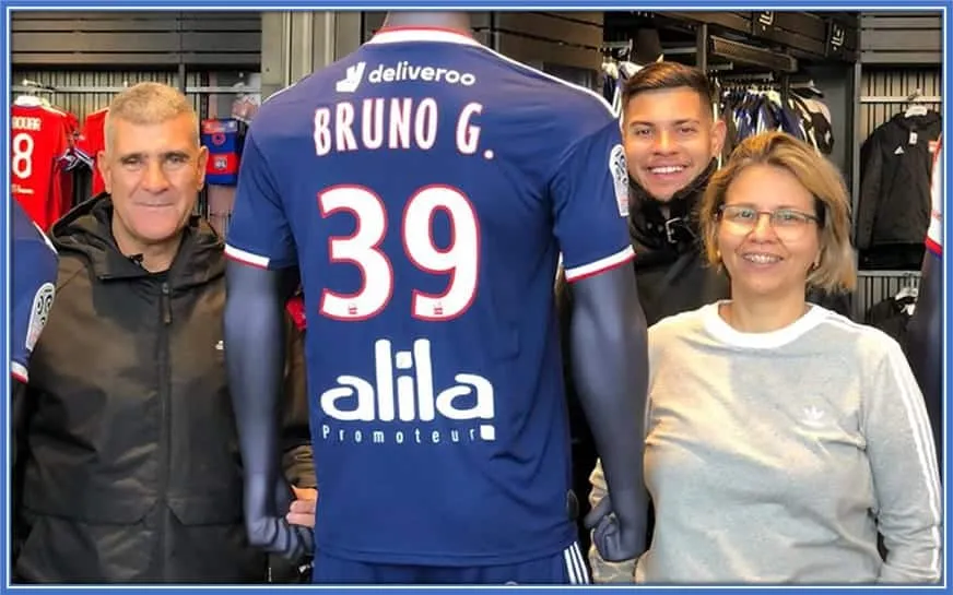 Parents of Bruno Guimarães were feeling excited about their son playing in Europe. They both stand at the sides of their family's pride - the number 39 shirt.
