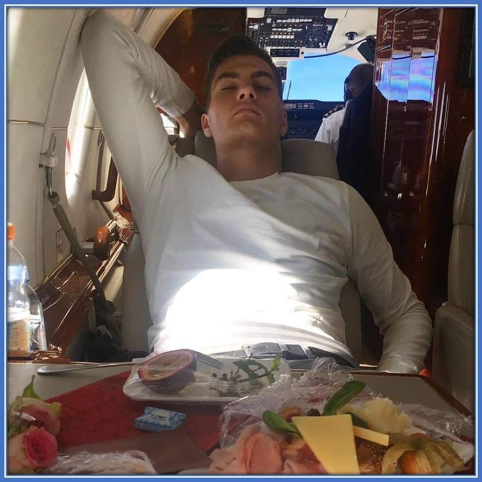 He easily relaxes in the private jet after lunch.