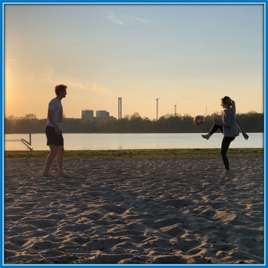 A photo of Kirsten Lepping and her husband playing beach soccer.