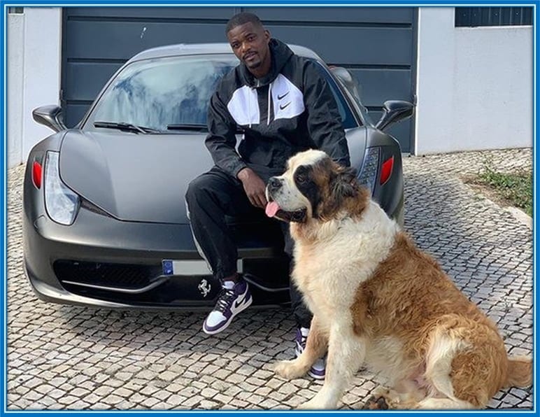 William sits on the bonnet of his Porsche Car with his late Dog by his side.