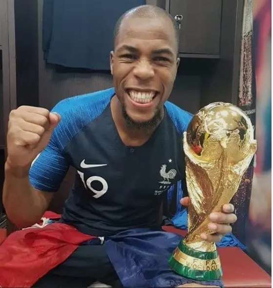 A happy Djibril Sidibe holding the 2018 FIFA World Cup.