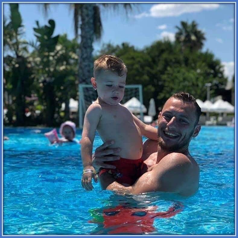 He enjoys swimming with his son. Indeed, it makes him quite happy.