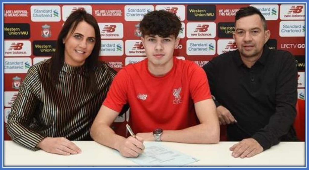 Here are Neco Williams' Parents - Emma and Lee. They took this photo at the time he signed his first Liverpool contract.