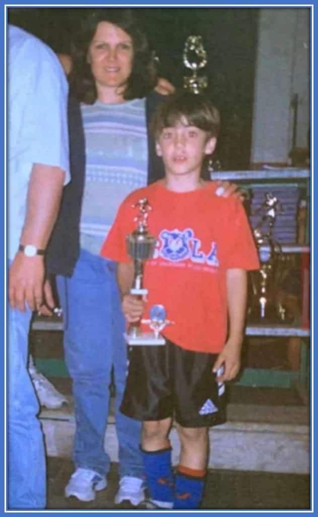 Here, young Nicolas celebrates a trophy moment with his Mum.