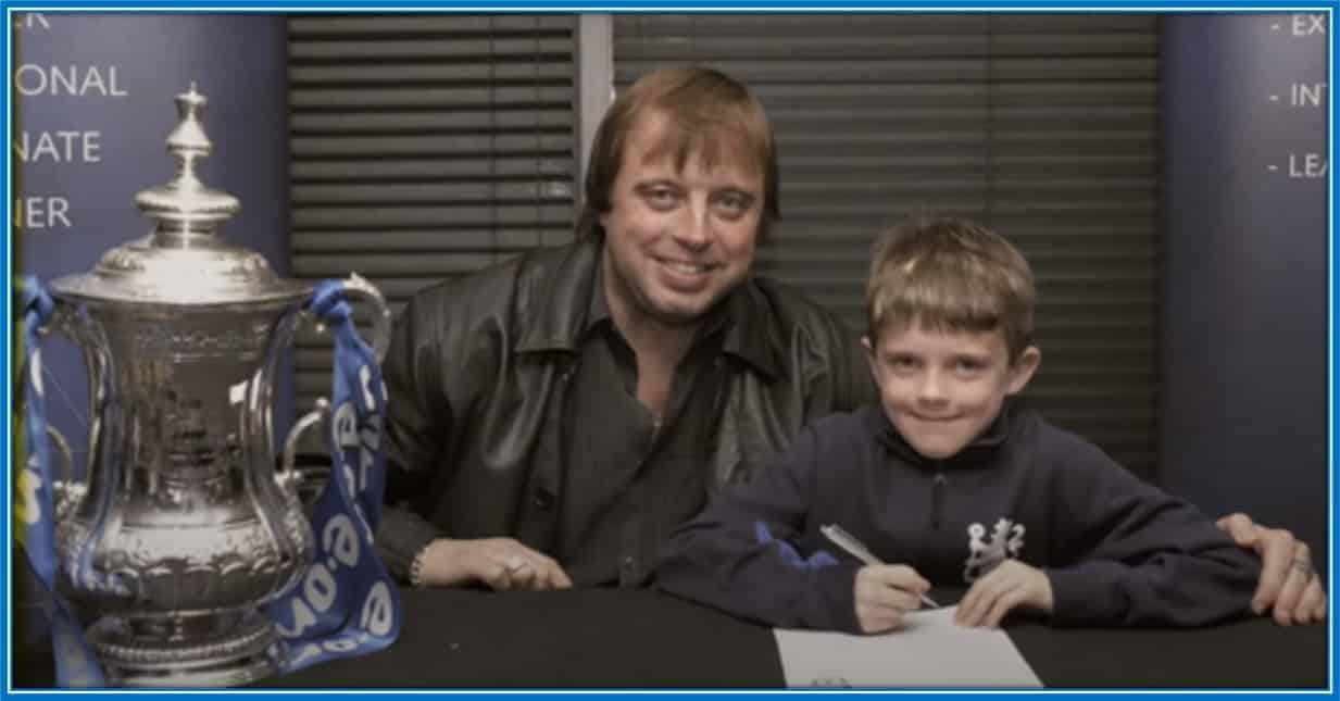 This is Conor Gallagher in his childhood. He is pictured signing his first Chelsea academy contract as an 8-year-old.