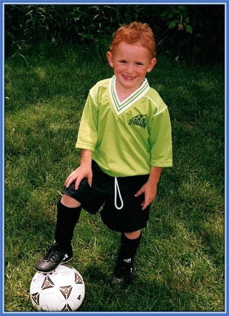 Young Sargent poses for a photo with his soccer ball.